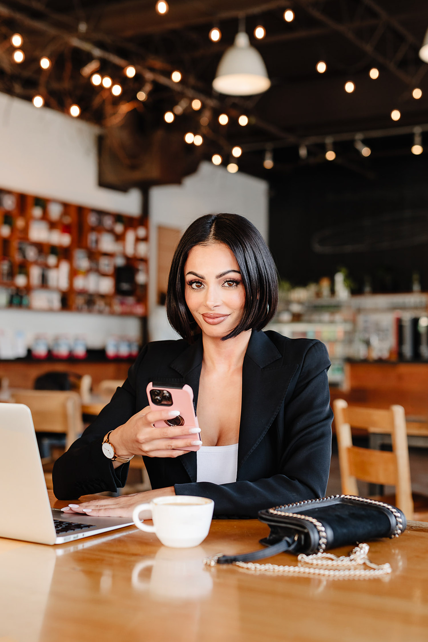 branding session for a matchmaker sitting at a table with a laptop and a phone